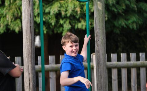 Boy in a blue t-shirt on a climbing frame